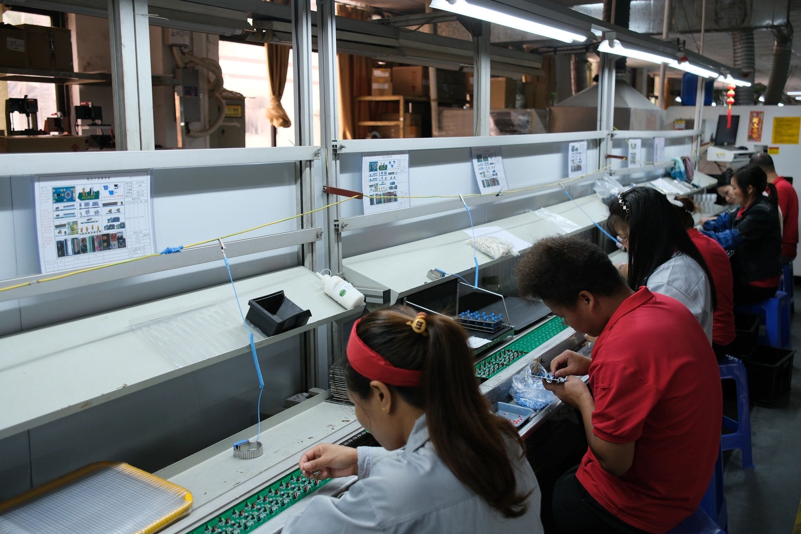 Production team working on through-hole board assembly